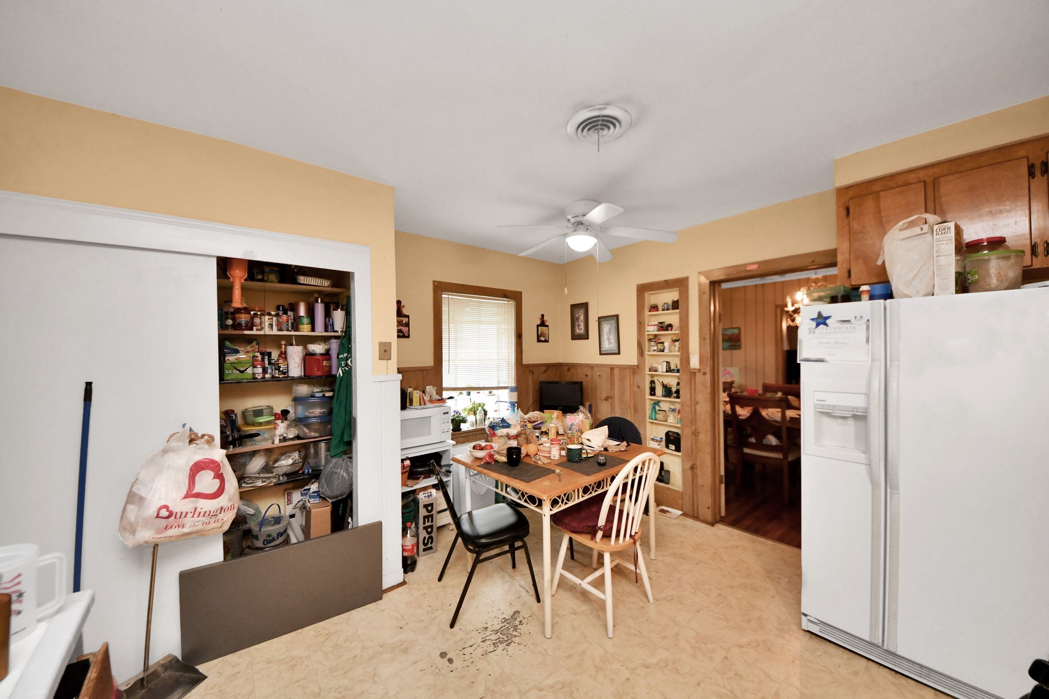 5134 Leeland Street Houston, TX 77023 - Photo 15 of 28 a dining room with furniture and a refrigerator