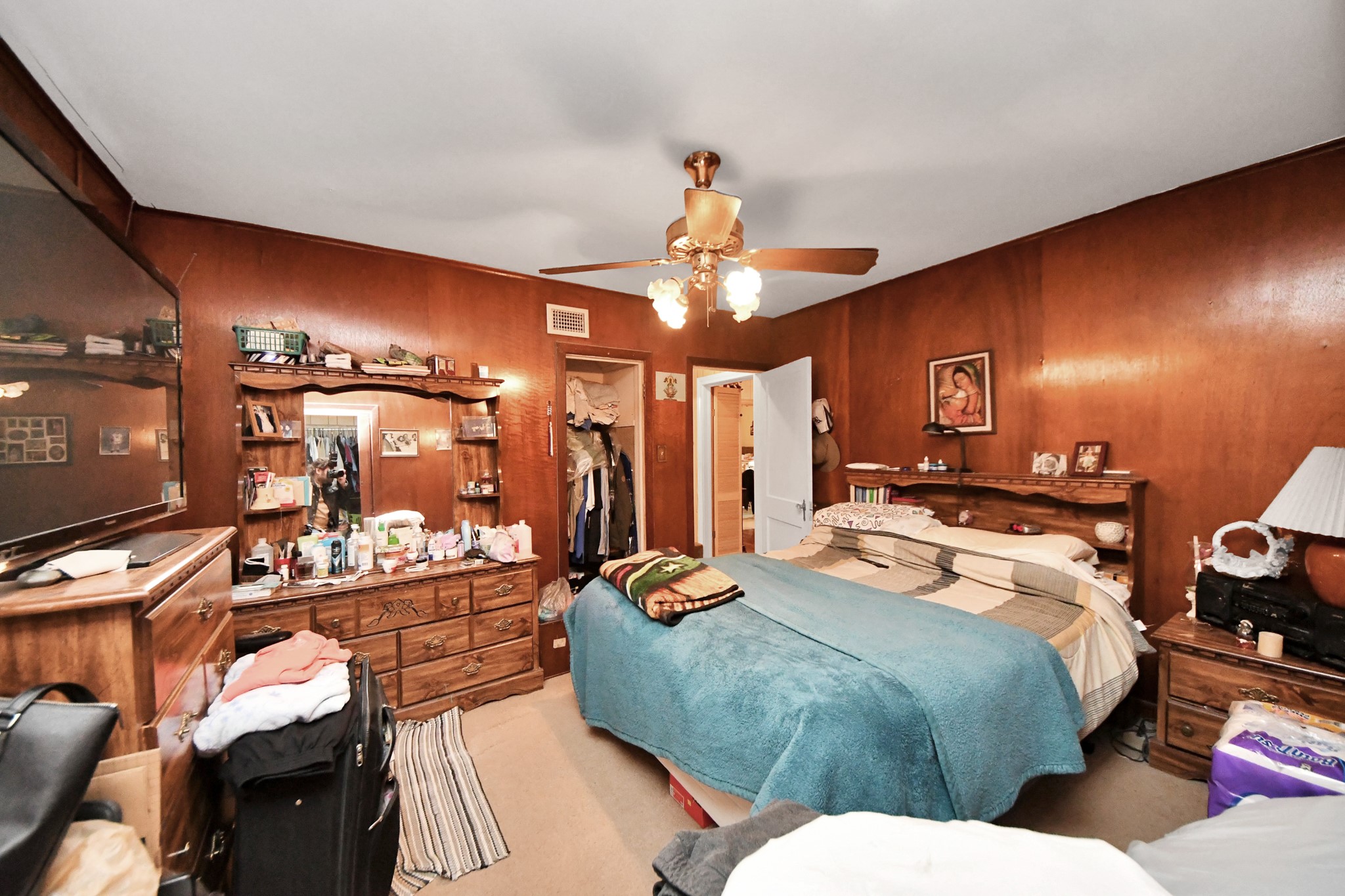 5134 Leeland Street Houston, TX 77023 - Photo 17 of 28 a bedroom with a bed and chandelier