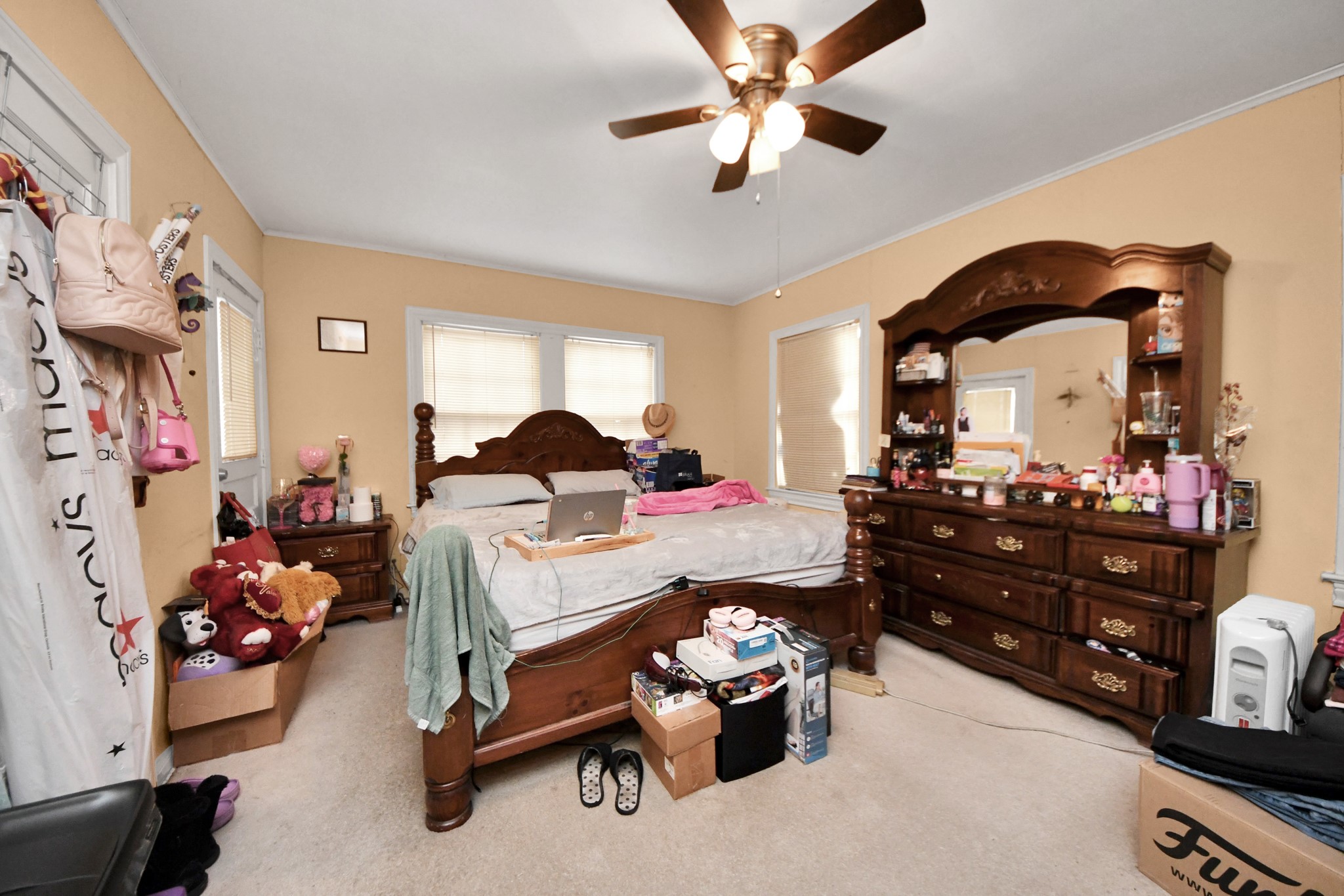 5134 Leeland Street Houston, TX 77023 - Photo 19 of 28 a bed room with furniture and a chandelier