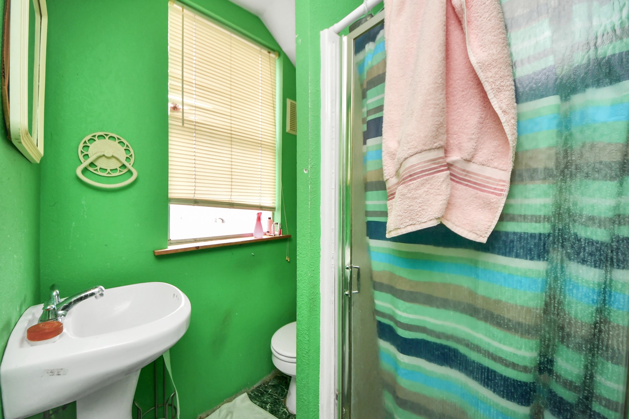5134 Leeland Street Houston, TX 77023 - Photo 23 of 28 a bathroom with a sink mirror and toilet