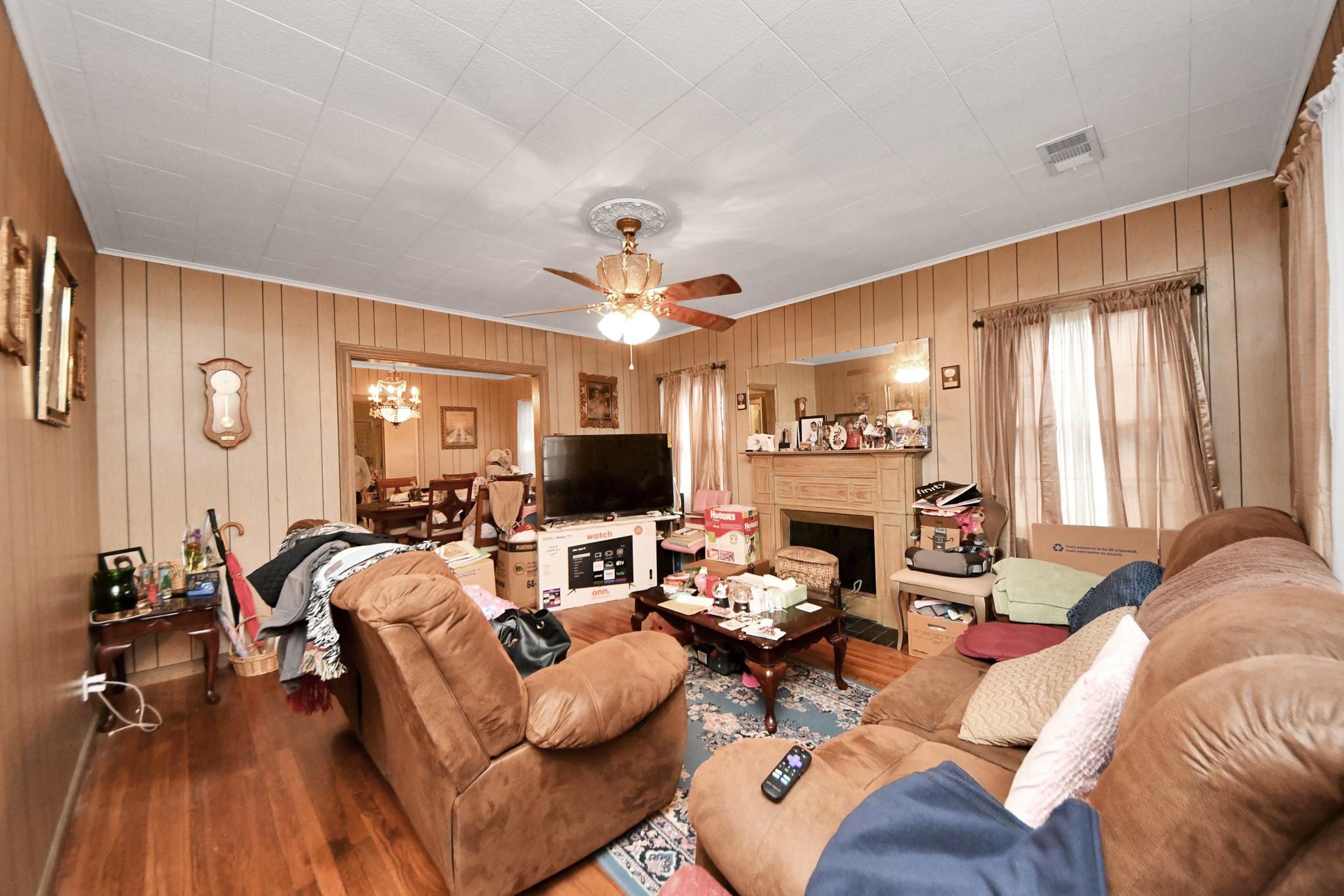5134 Leeland Street Houston, TX 77023 - Photo 7 of 28 a living room with furniture a fireplace and a flat screen tv
