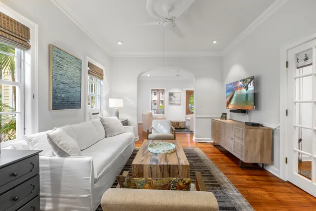 a living room with furniture and a wooden floor