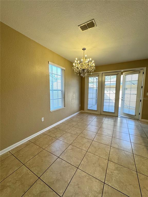 7752 Moser Avenue Windermere, FL 34786 - Photo 11 of 22 a view of an empty room with a chandelier