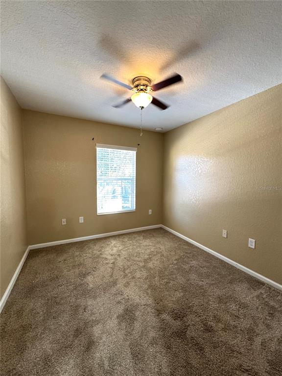 7752 Moser Avenue Windermere, FL 34786 - Photo 15 of 22 an empty room with windows and fan