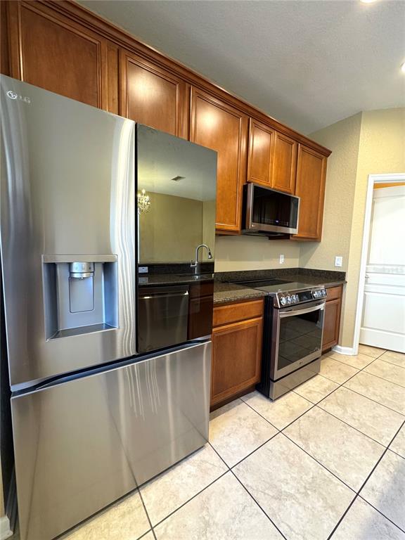 7752 Moser Avenue Windermere, FL 34786 - Photo 7 of 22 a kitchen with stainless steel appliances granite countertop a refrigerator and a stove top oven