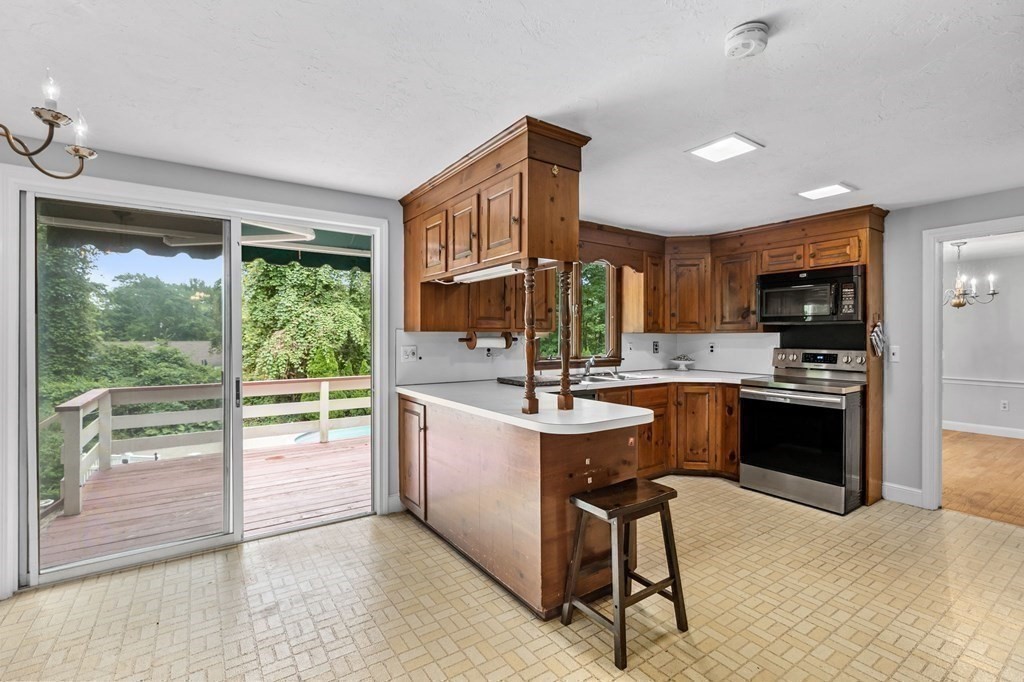 7 Conihasset Road Scituate, MA 02066 - Photo 11 of 34 a kitchen with kitchen island a large window cabinets and stainless steel appliances