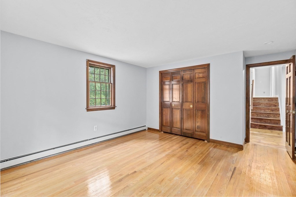 7 Conihasset Road Scituate, MA 02066 - Photo 18 of 34 an empty room with wooden floor and windows