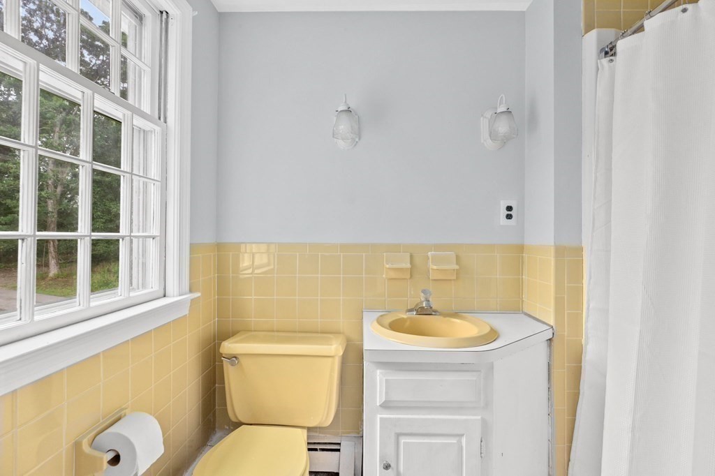 7 Conihasset Road Scituate, MA 02066 - Photo 22 of 34 a bathroom with a toilet sink and mirror
