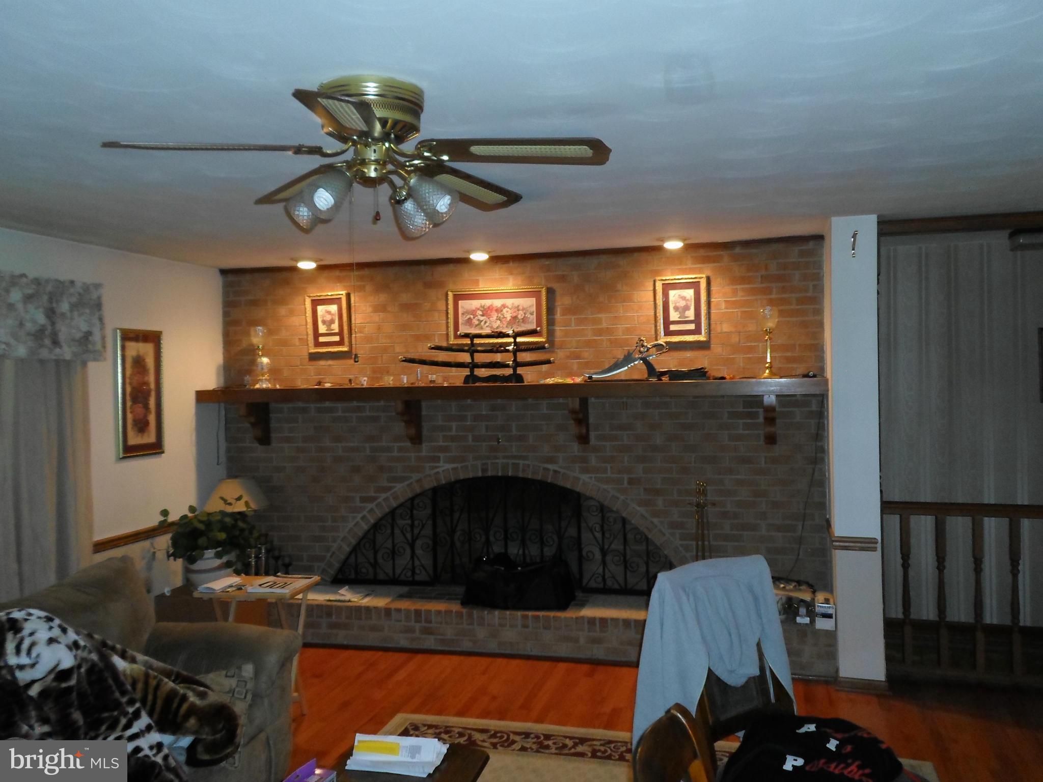 7410 South Osborne Road Upper Marlboro, MD 20772 - Photo 12 of 30 a living room with furniture and a fireplace