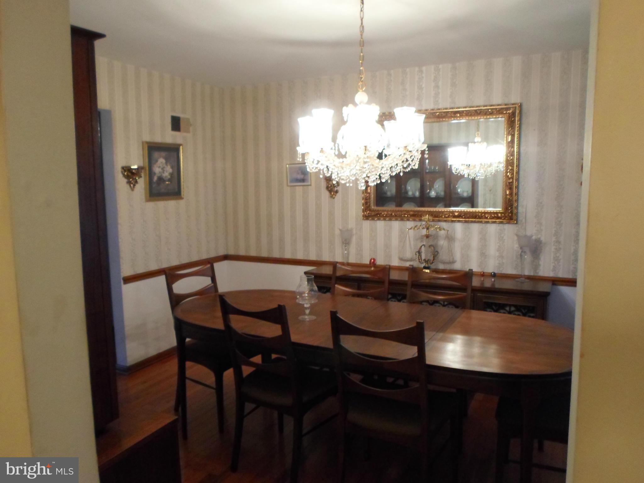 7410 South Osborne Road Upper Marlboro, MD 20772 - Photo 17 of 30 a view of a dining room with furniture and chandelier