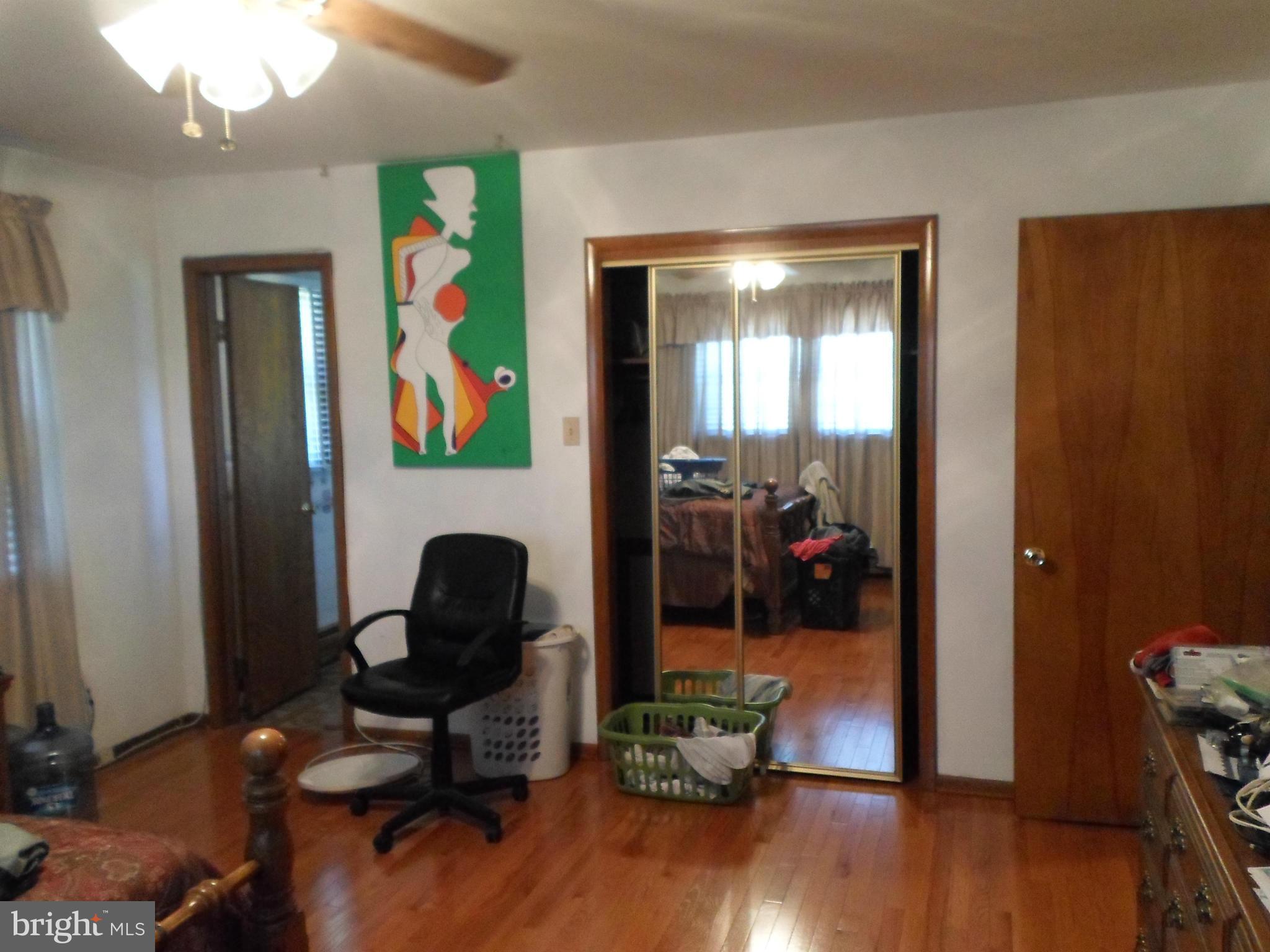 7410 South Osborne Road Upper Marlboro, MD 20772 - Photo 18 of 30 a view of a workspace with wooden floor and furniture