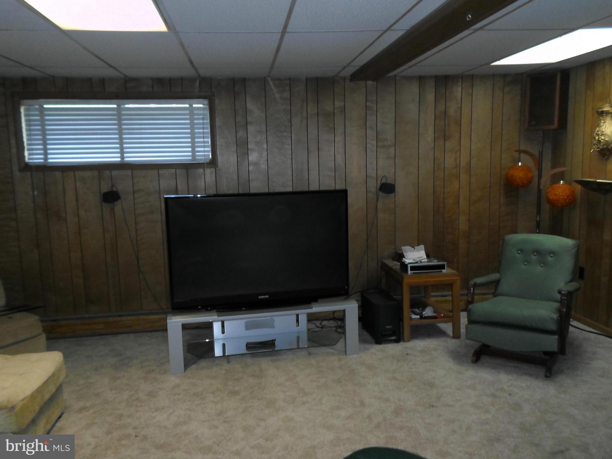 7410 South Osborne Road Upper Marlboro, MD 20772 - Photo 25 of 30 a living room with furniture and a flat screen tv