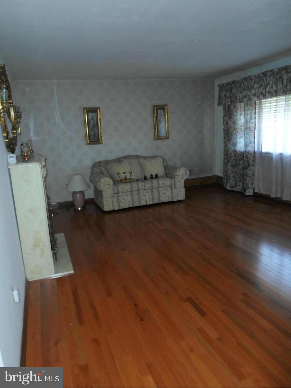 7410 South Osborne Road Upper Marlboro, MD 20772 - Photo 6 of 30 a bedroom with furniture and a wooden floor