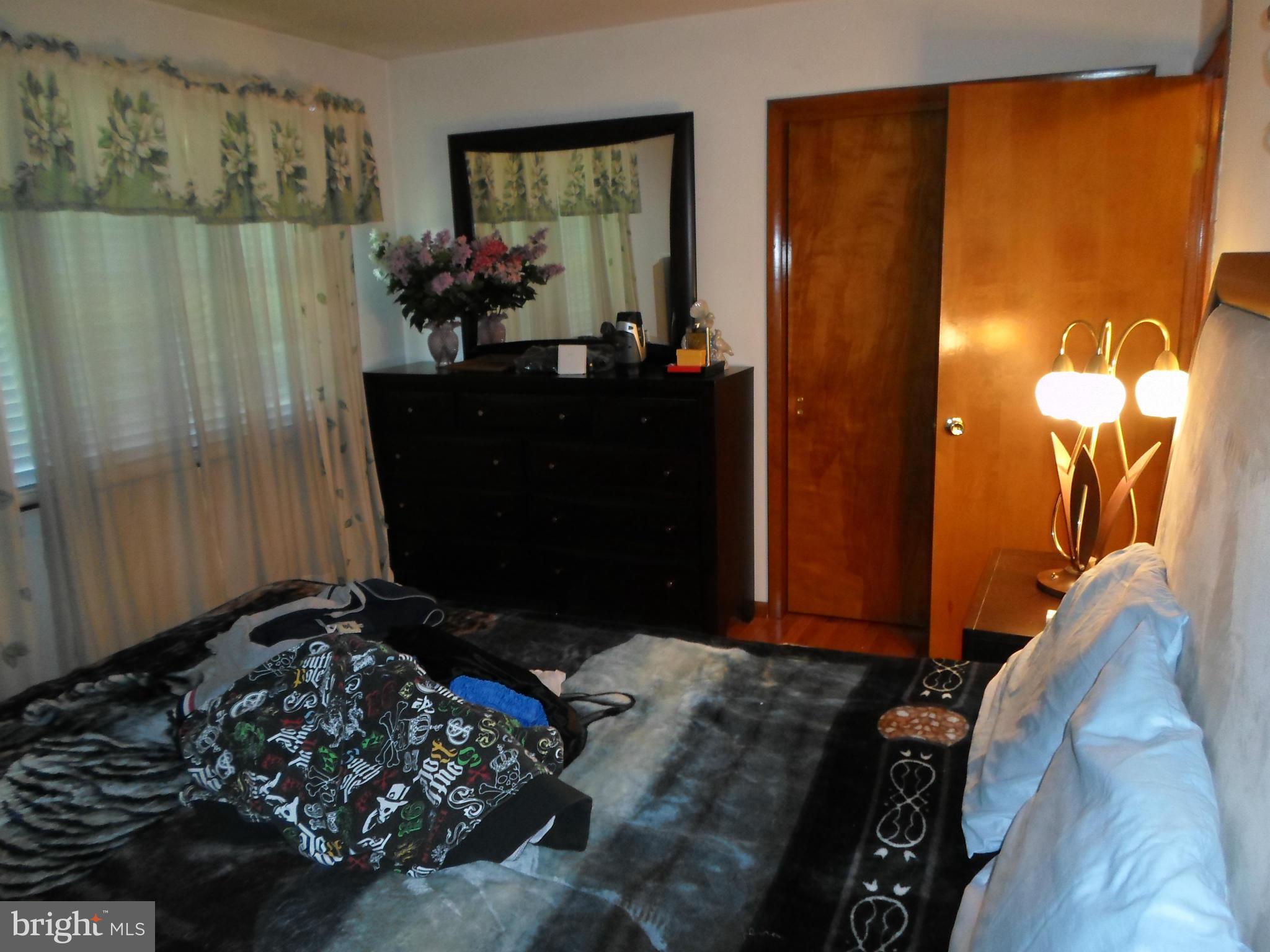 7410 South Osborne Road Upper Marlboro, MD 20772 - Photo 9 of 30 a bedroom with a bed and a mirror