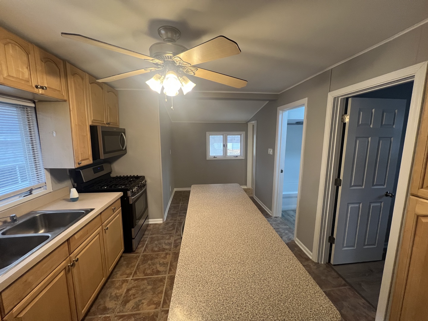 1817 Cora Street Crest Hill, IL 60403 - Photo 11 of 19 a kitchen with stainless steel appliances granite countertop a refrigerator a sink dishwasher a stove and a dining table with wooden floor