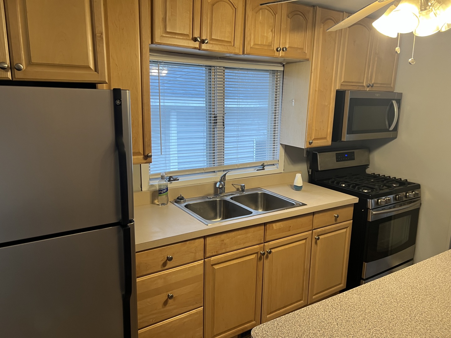 1817 Cora Street Crest Hill, IL 60403 - Photo 12 of 19 a kitchen with stainless steel appliances granite countertop cabinets and a refrigerator