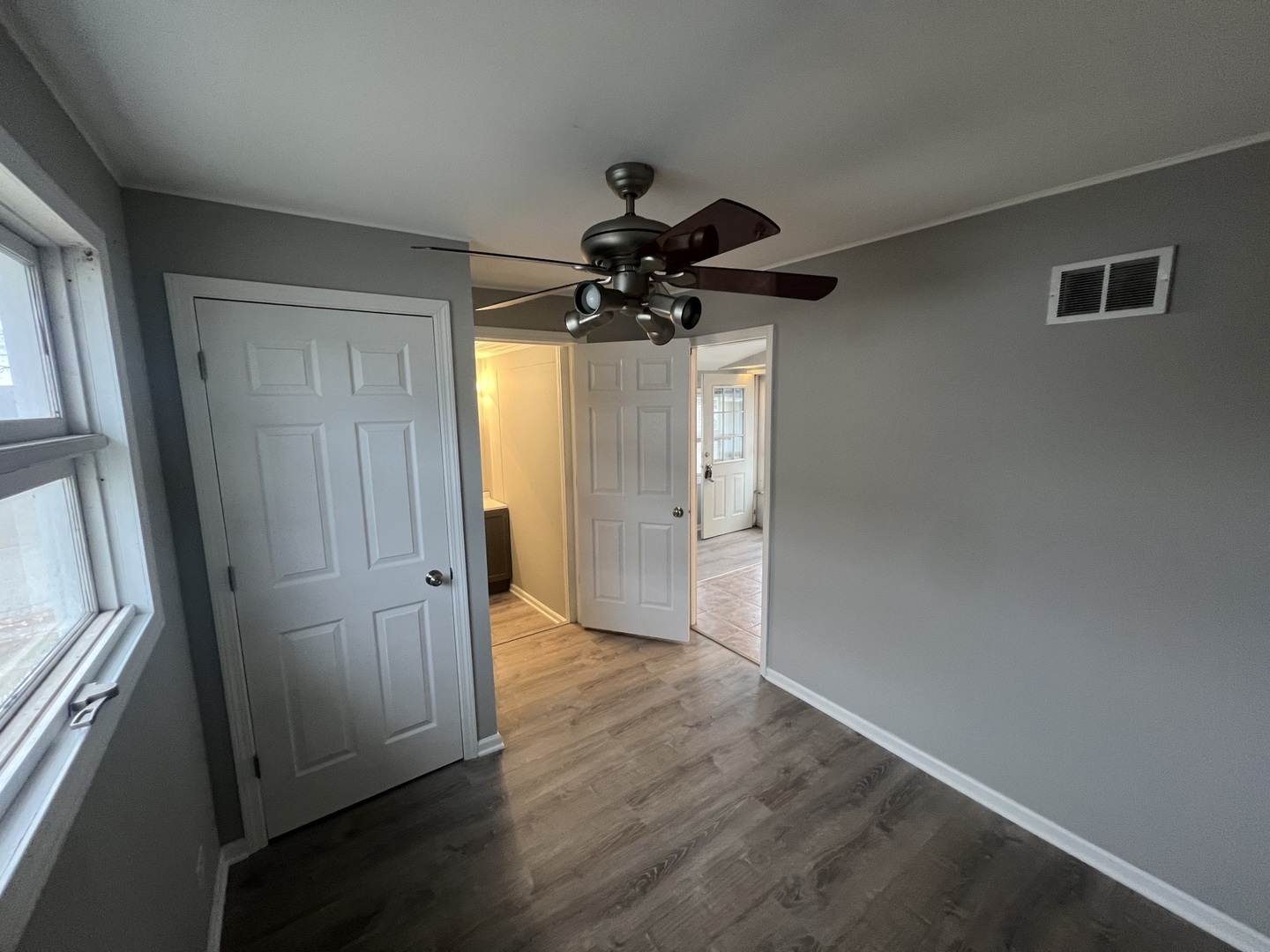 1817 Cora Street Crest Hill, IL 60403 - Photo 7 of 19 wooden floor in an empty room with a window