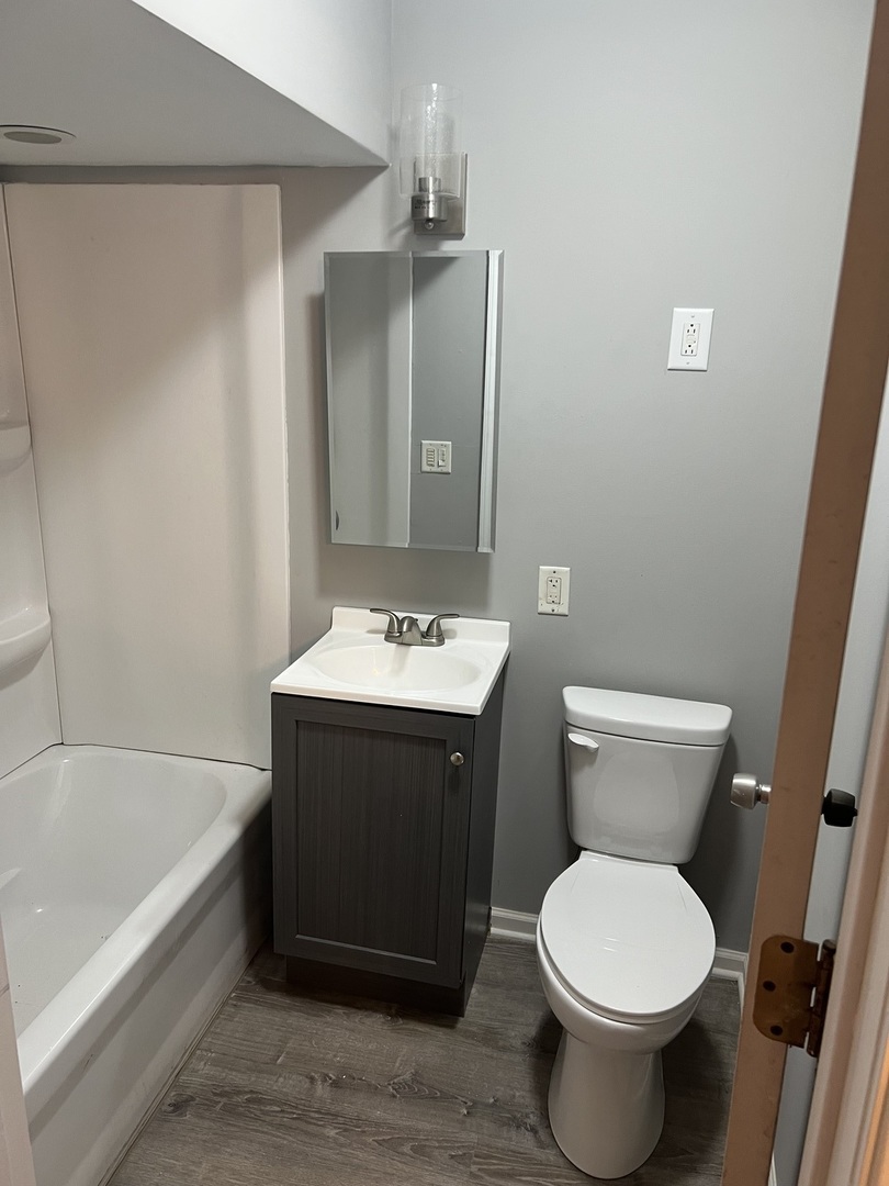 1817 Cora Street Crest Hill, IL 60403 - Photo 10 of 19 a bathroom with a sink toilet and shower