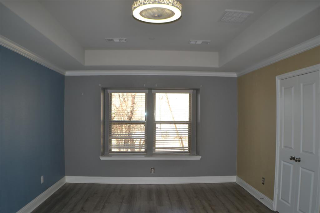 545 Teton Street Allen, TX 75002 - Photo 13 of 19 a view of wooden floor and windows in a room