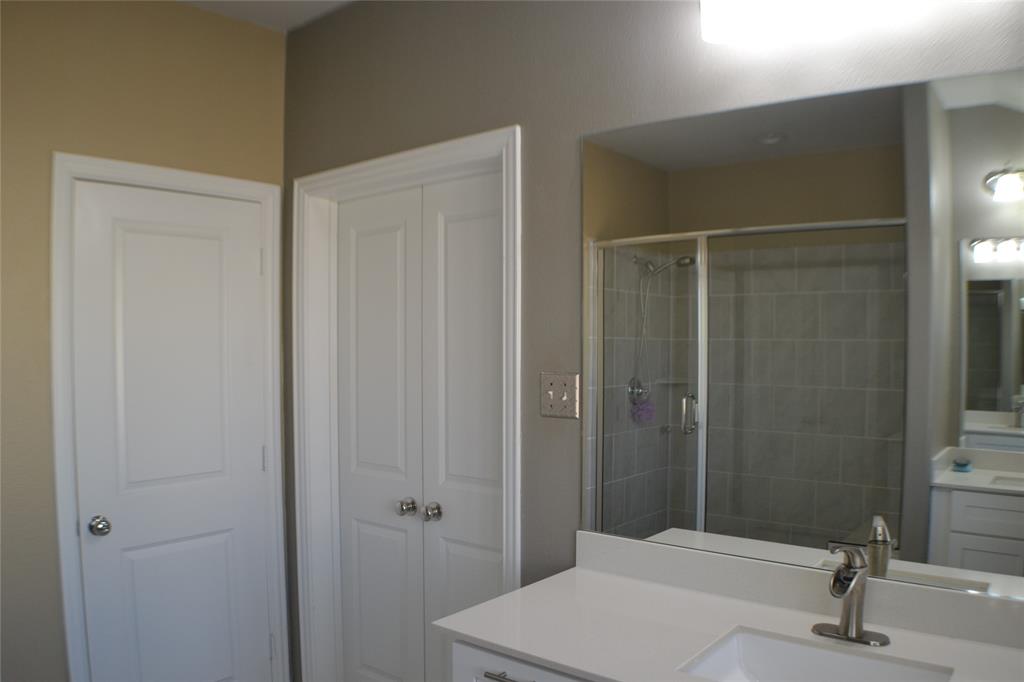 545 Teton Street Allen, TX 75002 - Photo 9 of 19 a bathroom with a sink and a mirror
