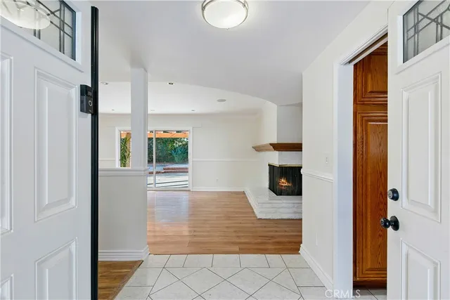 a view of a hallway with wooden floor and windows