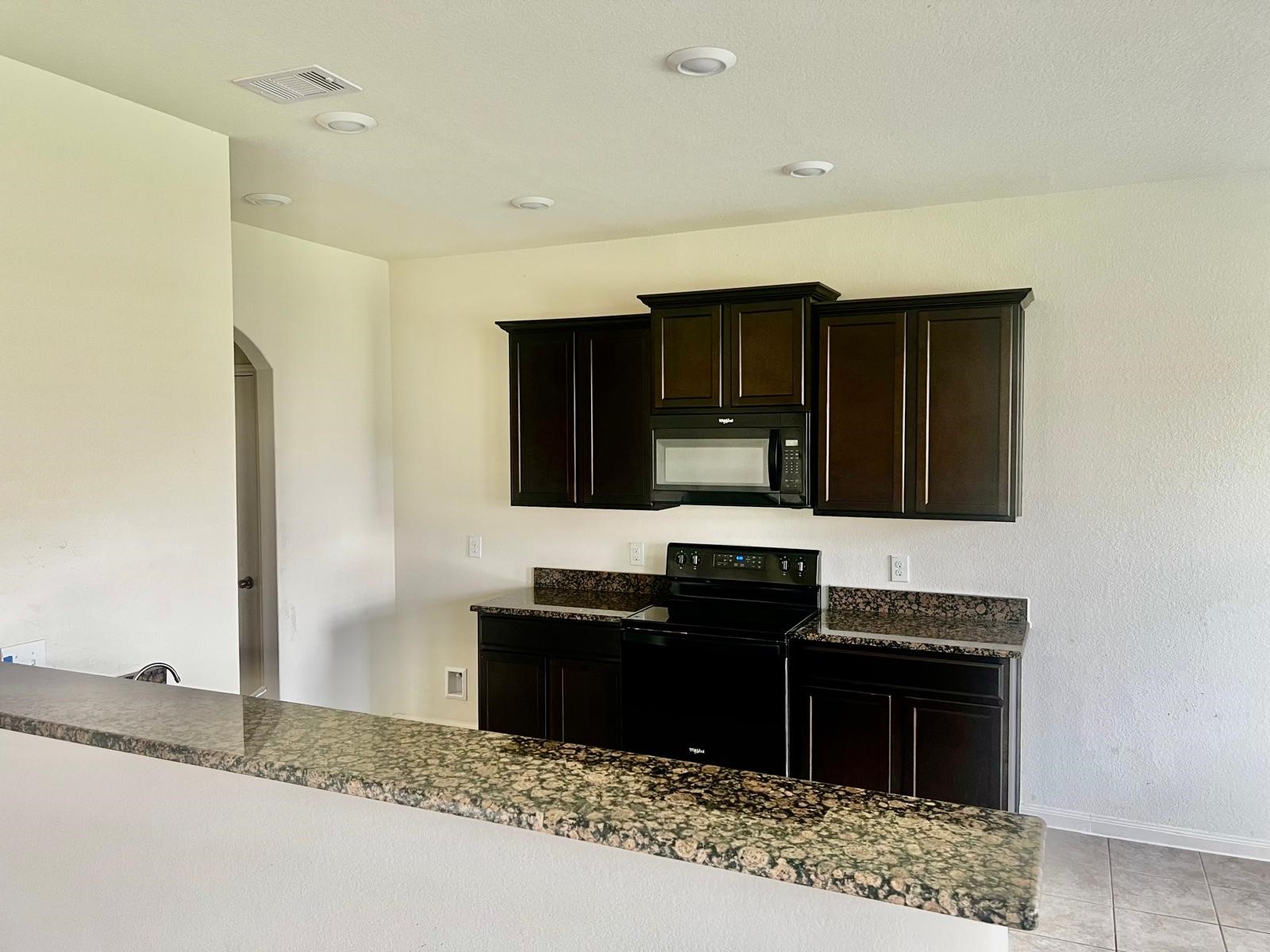 6159 El Oro Drive Houston, TX 77048 - Photo 3 of 10 a kitchen with stainless steel appliances granite countertop a stove and a microwave