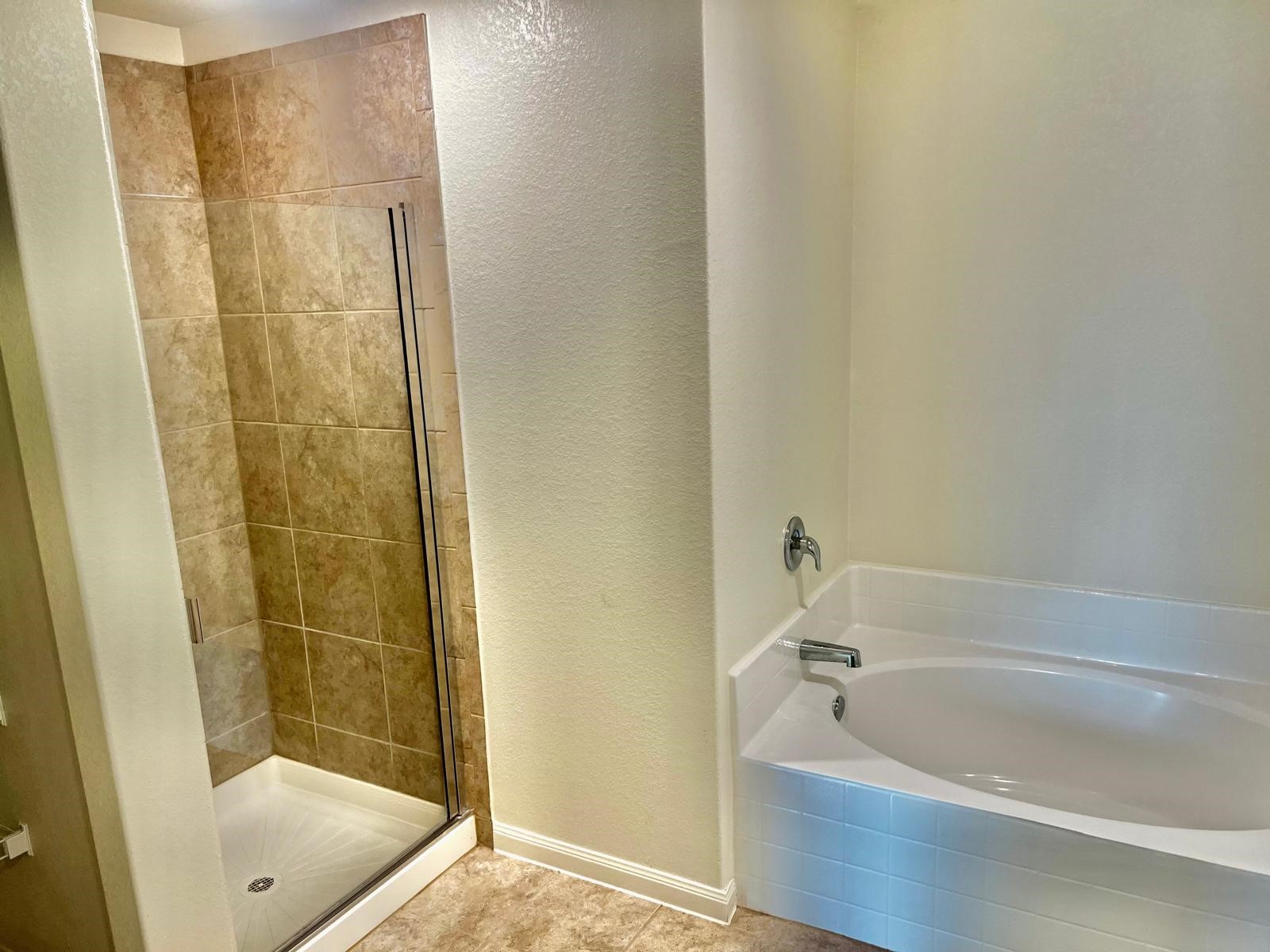 6159 El Oro Drive Houston, TX 77048 - Photo 8 of 10 a bathroom with a tub and shower