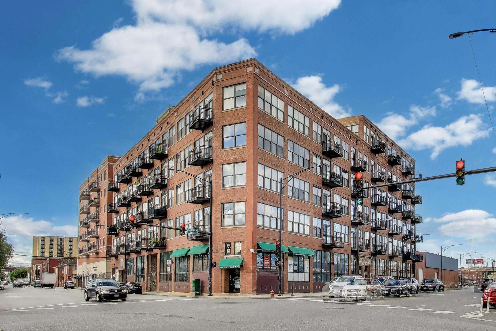 2310 South Canal Street, Unit 210 Chicago, IL 60616 - Photo 1 of 22 a view of a tall building next to a road