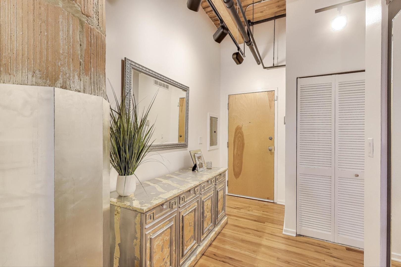 2310 South Canal Street, Unit 210 Chicago, IL 60616 - Photo 7 of 22 a bathroom with a granite countertop sink a mirror and shower