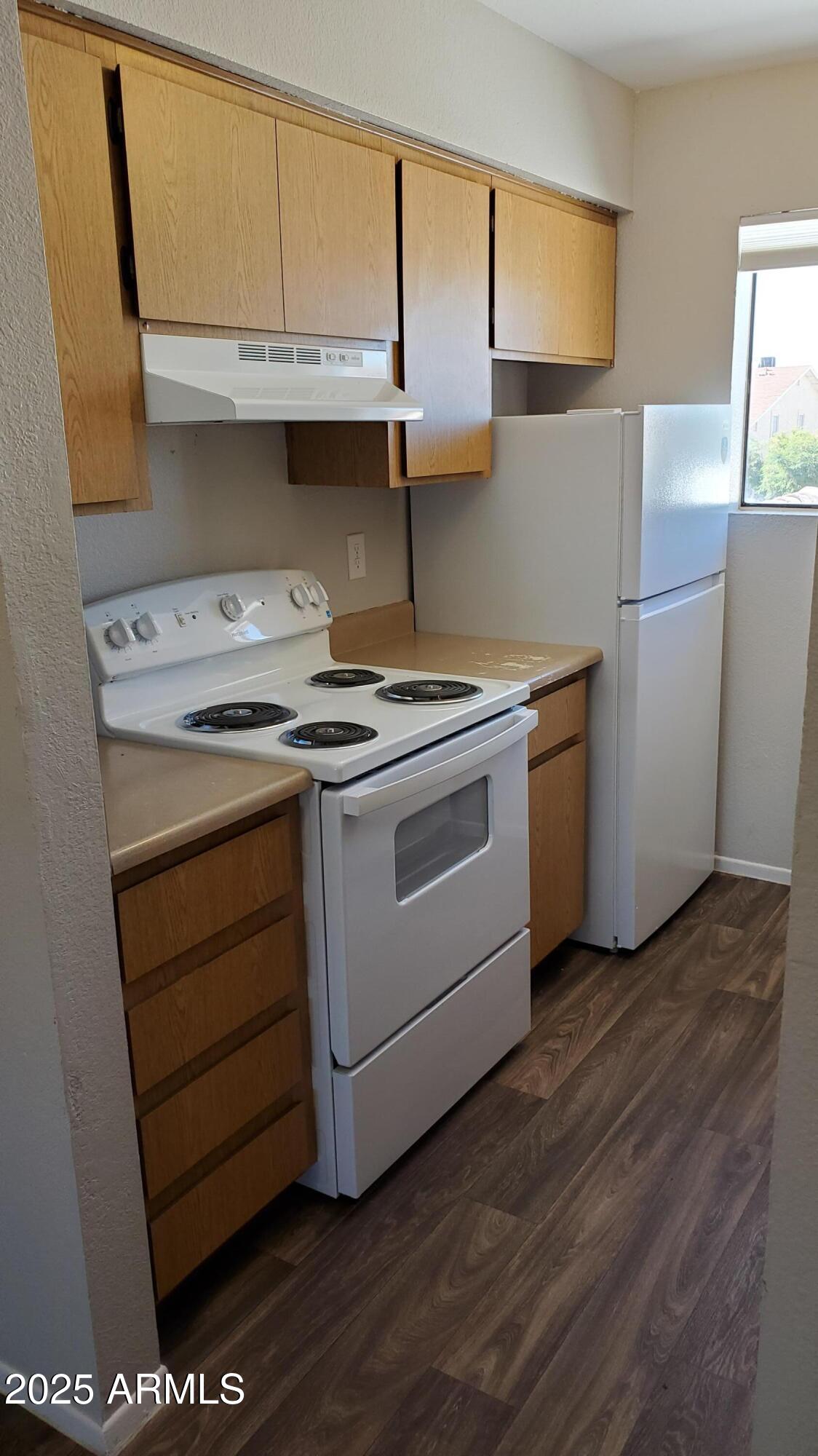 2737 North Salem, Unit 201 Mesa, AZ 85215 - Photo 9 of 17 a kitchen with a stove and a refrigerator