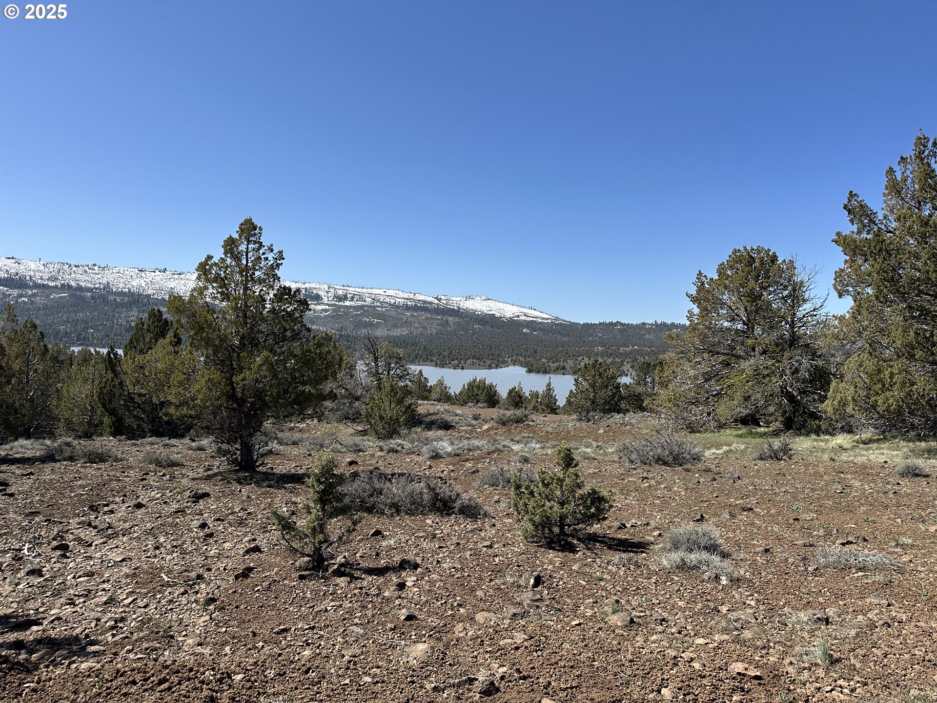 Cyhoya Way Lakeview, OR 97630 - Photo 17 of 36 a view of a dry yard with mountains in the background