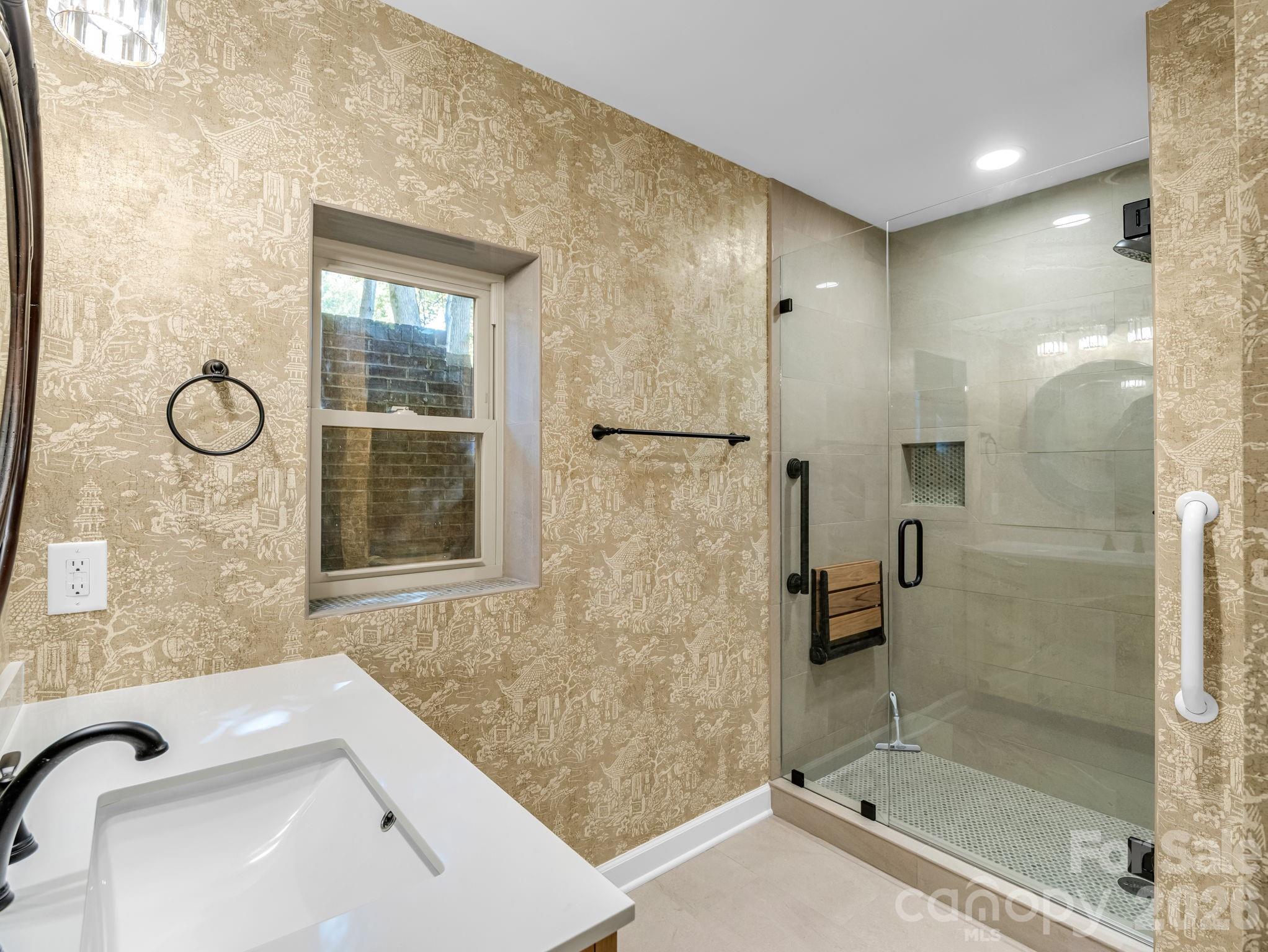 44 Jervey Road, Unit 4C Tryon, NC 28782 - Photo 19 of 35 a bathroom with a granite countertop sink a toilet and shower