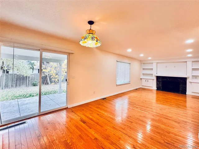 a view of empty room with wooden floor and outdoor space