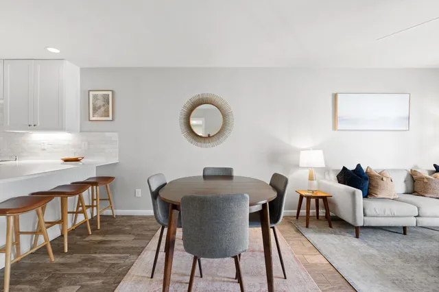 a living room with furniture a rug and a window