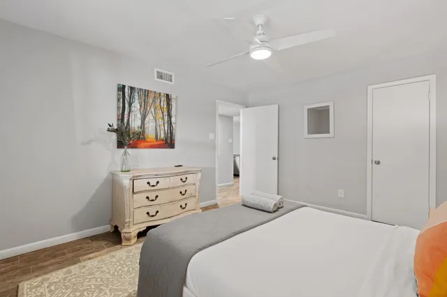 a bedroom with a bed and a chandelier