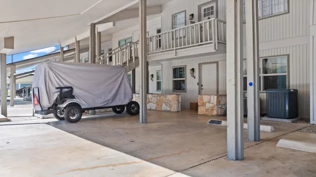 a view of balcony with car parked