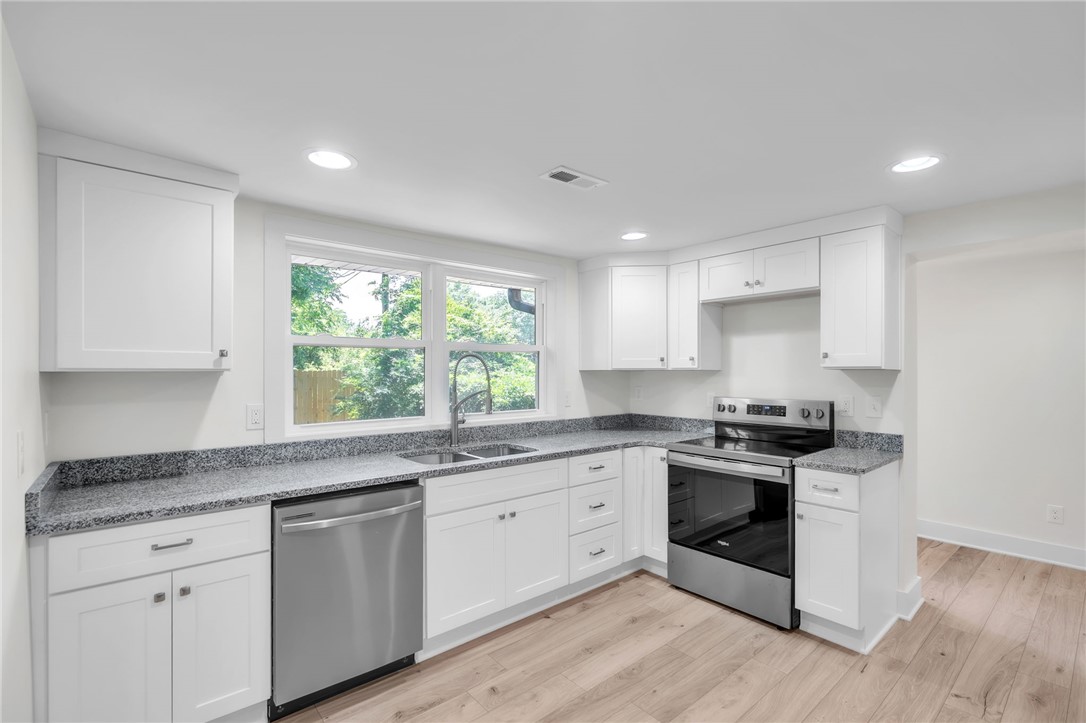 7 Beaverdam Road Williamston, SC 29697 - Photo 6 of 27 A well-appointed kitchen features new stainless steel appliances and abundant white cabinetry.