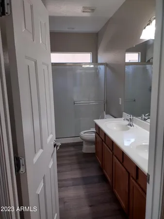 a bathroom with a double vanity sink and a mirror