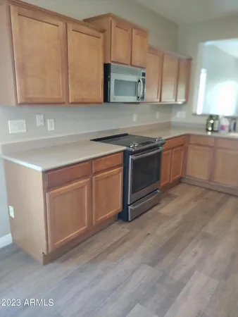 a kitchen with granite countertop wooden cabinets and white appliances