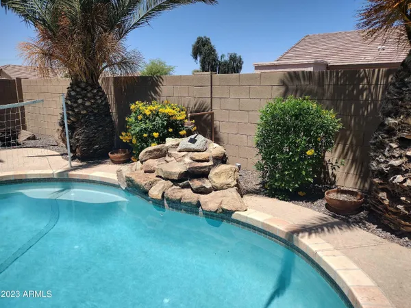 a view of a backyard with plants and a patio