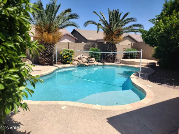 a view of a backyard with swimming pool
