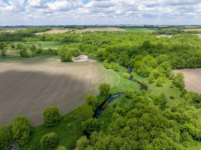 a view of a house with a yard covered in snow