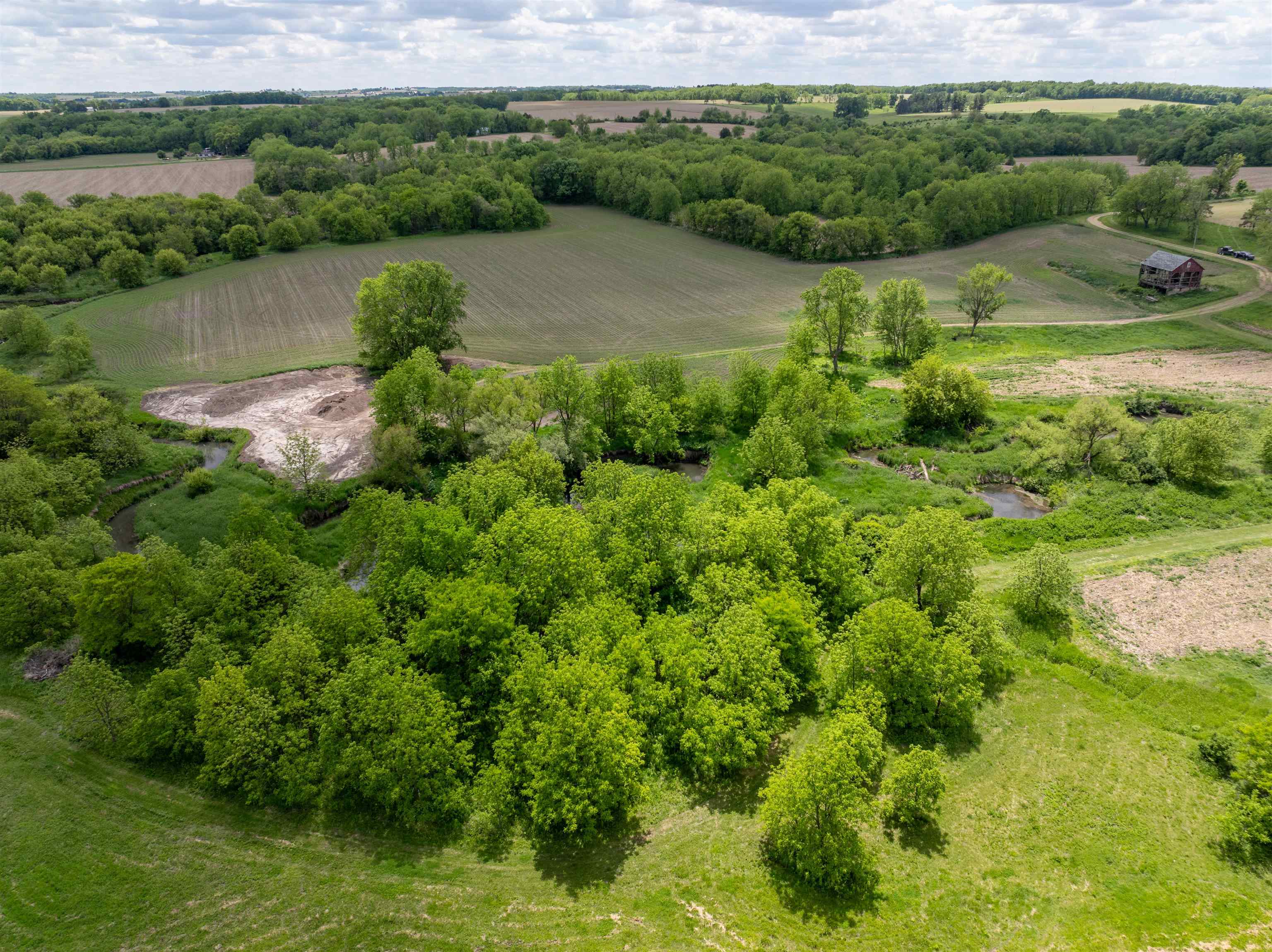 10385 North Rock City Road Leaf River, IL 61047 - Photo 31 of 99 an aerial view of green landscape with trees houses and lake view