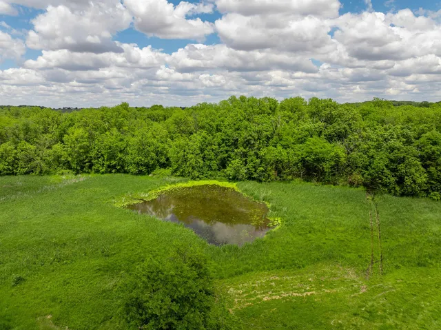 a large kitchen with a large window and stainless steel appliances