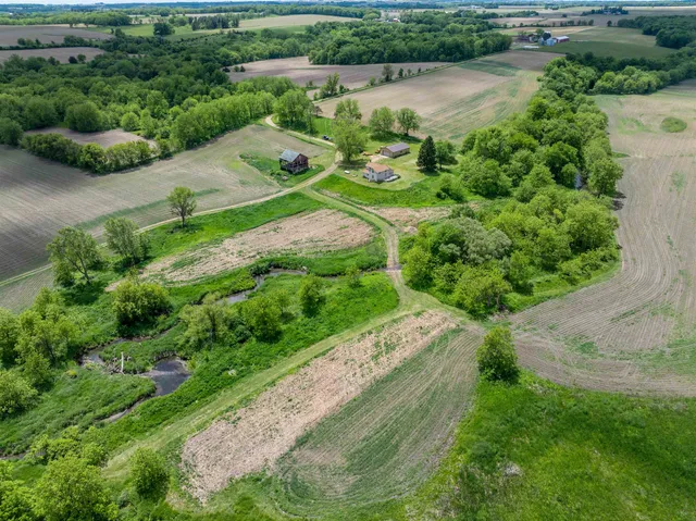 a view of an empty room with window and chandelier fan