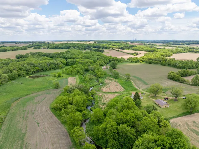 a view of a lush green outdoor space with a lake view
