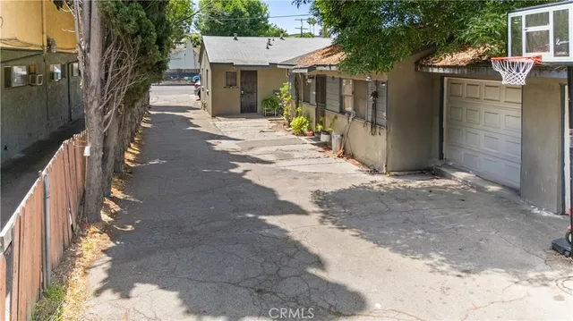 a view of a house with a tree in front of it
