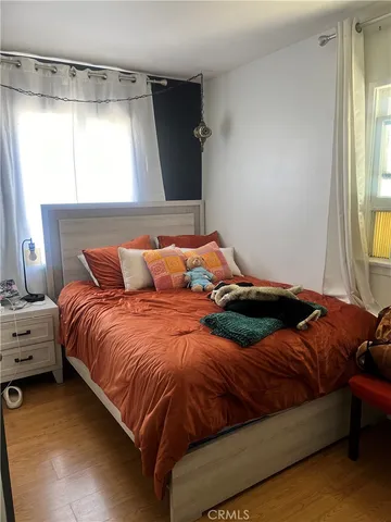 a bedroom with a bed and window