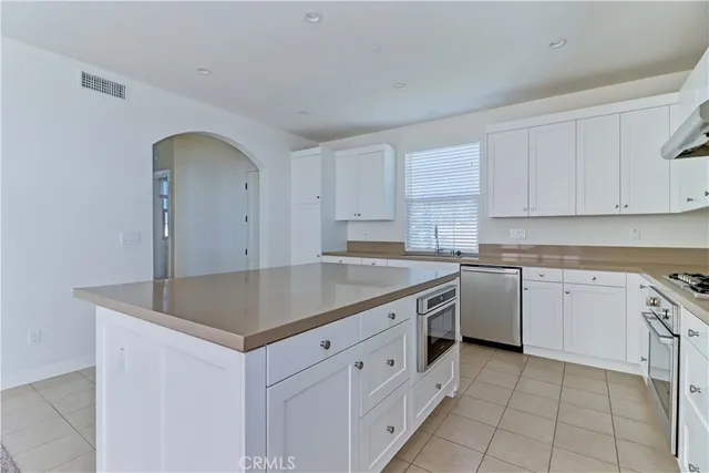 a kitchen with cabinets appliances and a sink