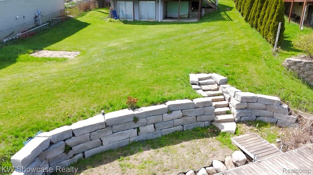 6354 Bennett Lake Road Fenton, MI 48430 - Photo 4 of 41 View of yard featuring an outdoor structure and a patio area